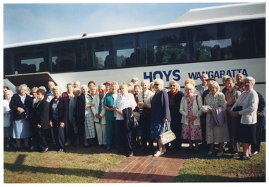 COL photo of a large group of people standing in front of a coach bus. The words "HOYS Wangaratta" are painted on the side of the coach. This photo depicts a view of the majority of the coach, with the front and back ends not in frame.