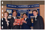 COL photo of four people standing next to one another in front of a three-panelled display board. The two people in the middle are holding an open book titled, "Exercise beats Arthritis". At the top of the display board is the text, "ARTHRITIS FOUNDATION OF VICTORIA", with the telephone number "862 2555" below that.