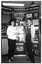 B&W photo of two women standing in front of a large multipanel display board titled, "Arthritis Foundation of Victoria". The board contains text and Photographs about the Foundation and its services.