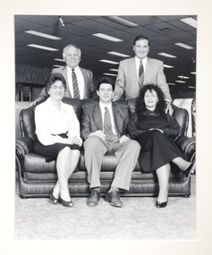 a group of 5 people smiling. 