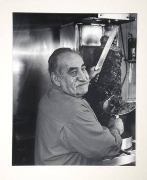 A man at a kabab shop. 