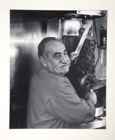 A man at a kabab shop. 