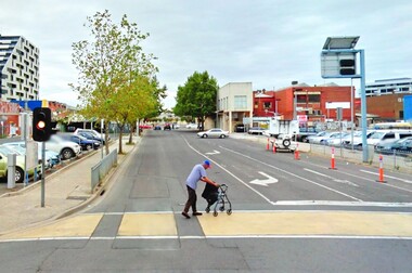 Photo of an elderly man crossing the street.