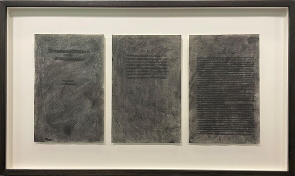 Three pages of a dictionary, which has been effaced by burning and charcoal