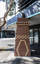 A brick sculpture of a chimney in a suburban street