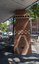 A brick sculpture of a chimney in a suburban street