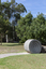 A concreate path leading to a concrete path sculpture giving the illusion the path as been rolled out. 