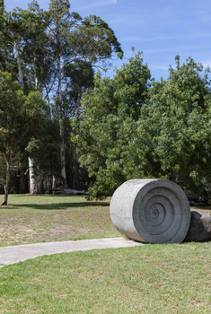 A concreate path leading to a concrete path sculpture giving the illusion the path as been rolled out. 