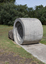 A concreate path leading to a concrete path sculpture giving the illusion the path as been rolled out. 