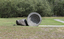 A concreate path leading to a concrete path sculpture giving the illusion the path as been rolled out. 