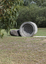 A concreate path leading to a concrete path sculpture giving the illusion the path as been rolled out. 