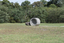 A concreate path leading to a concrete path sculpture giving the illusion the path as been rolled out. 