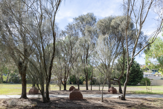 Brick sculptures installed among sheoaks.