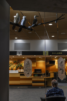 Three cormorant sculptures on a metal pole 