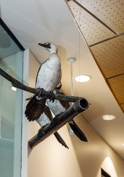 Three cormorant sculptures on a metal pole 
