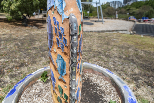 A large scale mosaic fish sculpture in a public park. 