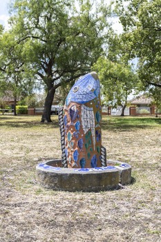 A large scale mosaic fish sculpture in a public park. 