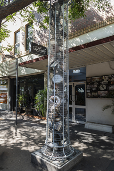 A series of large metal sculptures full of kitchenware (pots and pans etc)