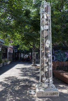 A series of large metal sculptures full of kitchenware (pots and pans etc)