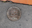 Lange bronze coins with Greek, Turkish and Italian iconography inlayed into the footpath. 
