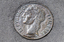 Lange bronze coins with Greek, Turkish and Italian iconography inlayed into the footpath. 