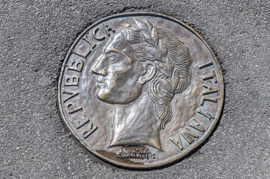 Lange bronze coins with Greek, Turkish and Italian iconography inlayed into the footpath. 