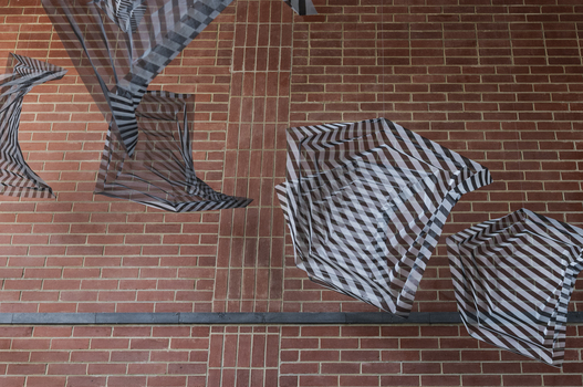 Hanging geometric forms in an entrance foyer