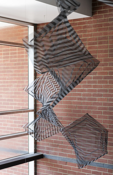 Hanging geometric forms in an entrance foyer