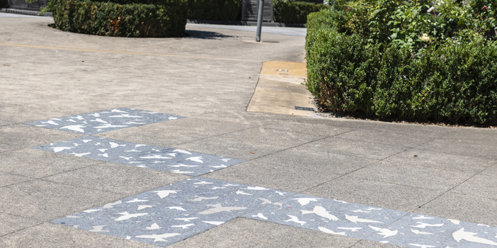Pavers in a public space featuring a stylised flock of birds
