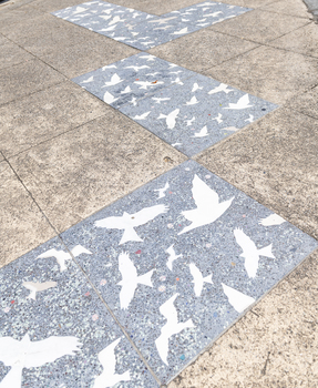 Pavers in a public space featuring a stylised flock of birds