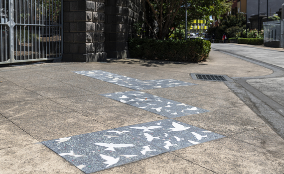 Pavers in a public space featuring a stylised flock of birds