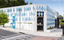 The exterior of a small library building covered in approximately 100 blue metal diamond shaped motifs. 