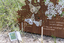 A large rusted cut out sculpture with native floral and emblems form the local area. It also includes 3 silver butterfly's. It is located in a bush setting along a creek.