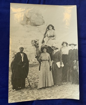 Black and white photograph of 5 women and 1 man [presumably the guide] in front of the Great Sphinx of Giza. Ethel Forsyth is sitting atop a camel, Agnes Jackson is one of the women [and possibly Maude Carlisle]. 
