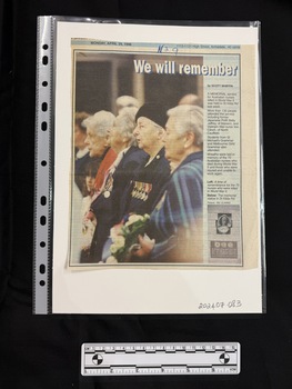 Newspaper clipping with one large photograph, single column of text and a second small photograph at the bottom of the column of text.  Clipping includes the date the newpaper was published and the address of the newspaper.