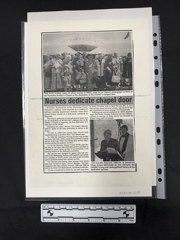 Photocopy of an article with two photos embedded.  Two columns of text.  Large photo at top of article of a group of happy women standing in front of a Soldier's Chapel.  Smaller photograph of a man in uniform speaking at a podium with a man in religious garb behind him.