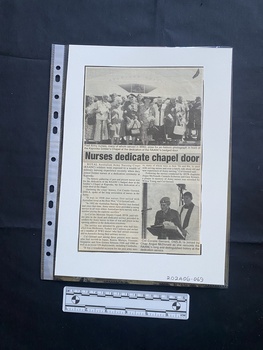 An article with two photos embedded.  Two columns of text.  Large photo at top of article of a group of happy women standing in front of a Soldier's Chapel.  Smaller photograph of a man in uniform speaking at a podium with a man in religious garb behind him.