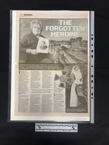 Full page newspaper clipping with two large black and white photographs and four columns of text.  The largest photograph is of an older woman sitting in a cemetary holding an old portrait photograph of a woman in a nurses uniform.  Ther is also an old photograph of a woman in a nurses uniform standing behind a chair.