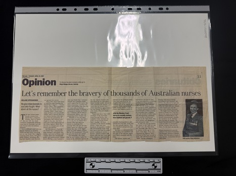 Newspaper clipping with a black and white photograph on the right of a smiling woman in military nurses uniform.  Article has seven columns of text.