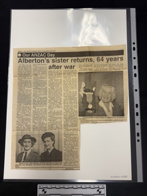 Newspaper clipping with two black and white photographs.  One is of a smiling elderly woman showing a medal to the camera, the other is of two younger women in military uniforms smiling at the camera.  The article has seven columns of text.