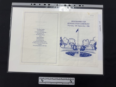 A printed document in blue ink on white paper, single fold with four pages.  Front page has drawing of landscape with flagpole and all other pages are textual.