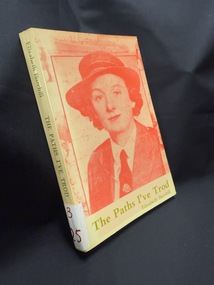 Book with green text on cover and spine and red image on cover