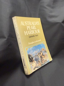 Paperback book with olive green cover and spine, cover also has a partial image of an artwork