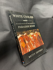 Black paperback book with white and orange writing on cover and spine and colour photograph on front cover