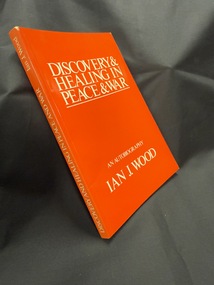 Red paperback book with white text on spine and cover, spine writing from bottom to top