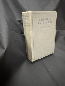 Grey hardback book with blue writing on cover and spine