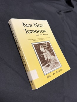 Paperback book with a yellow dustjacket that has a sepia photo on the cover and black writing on the cover and spine