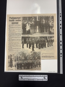Clipping with three black and white photographs of people, many in uniform in formation and one column of text