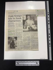 Article with two black and white photographs, four columns of text and a small paragraph clipping attached with corrections printed after the article.  Parts are highlighted in green highlighter.