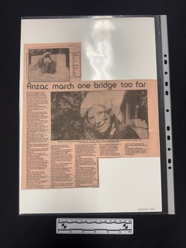 Article with two black and white photographs, five columns of text and printed on paper with a pink hue